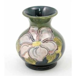 A Moorcroft Clematis posy vase, post war, decorated in shades of blue, green, pink and yellow aga...