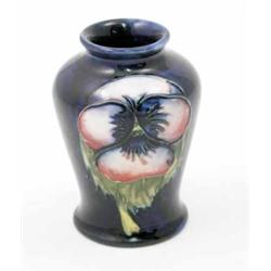 A Moorcroft pansy posy vase, circa 1935, decorated in shades of blue, pink, green and yellow agai...