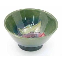 A Moorcroft Pansy conical bowl, circa 1953-78, decorated in shades of green, red and blue, agains...