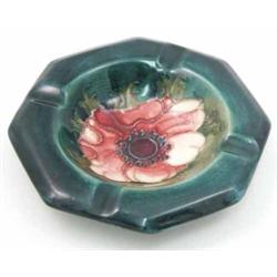 A Moorcroft Anemone octagonal ashtray, circa 1953-78, decorated in shades of green, red and blue,...