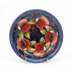 A Moorcroft Pomegranate shallow bowl, circa.1928-49, decorated in shades of blue, green and orang...