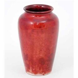 A Moorcroft flambe vase, with flared rim, circa.1925, typically decorated with a mottled red grou...