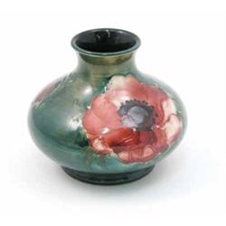 A Moorcroft Anemone squat vase, circa 1953-78, decorated in shades of green, red and blue against...