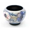 Image 1 : A Moorcroft Anemone vase, circa 1940, decorated in shades of blue, pink and green against a paled...