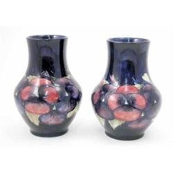 A near pair of identical William Moorcroft pansy vases, circa.1925, decorated with an encircling...