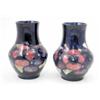 Image 1 : A near pair of identical William Moorcroft pansy vases, circa.1925, decorated with an encircling...