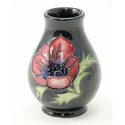 A Moorcroft anemone posy vase, circa 1999, decorated in shades of blue, pink and green against a...