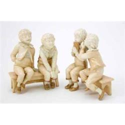 A pair of Hadley Worcester figure groups, schoolboys seated on benches, verses by Goldsmith print...