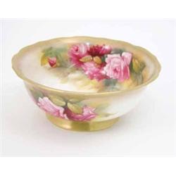 A Royal Worcester bowl, painted with pink roses and gilt borders, date code 1931, 8ins...