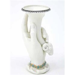 A Royal Worcester 'hand' vase, the hand holding a tapering vase with ram's head terminal, date co...