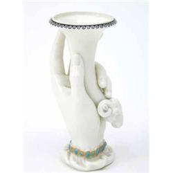 A Royal Worcester 'hand' vase, the hand holding a tapering vase with ram's head terminal, date co...