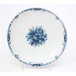 A Worcester saucer dish, painted with central flower in underglaze blue and bordered by moulded d...