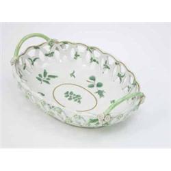 An oval Worcester basket, painted with leaves in green enamel, possibly by James Giles, twin hand...