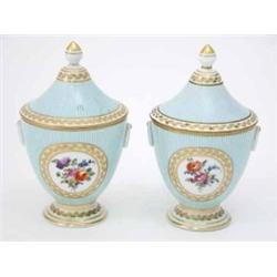 A pair of Sevres-style vases and covers, each of pedestal shape with two floral panels painted ag...