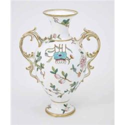 A Victorian Coalport two-handled vase, enamelled with peonies in Oriental manner, on pedestal bas...