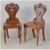 Image 1 : A pair of Victorian mahogany hall chairs with floral carved backs on turned tapered legs....