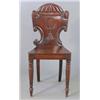 Image 1 : A Victorian mahogany hall chair with carved back on tapered legs....