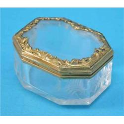 An early 19th century Continental rock crystal snuff box, of octagonal form with gilt scrollwork...