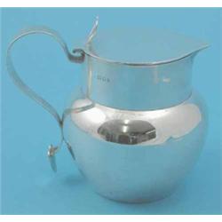 A George V bulbous silver lidded jug, with scroll handle, 1923. 16oz...