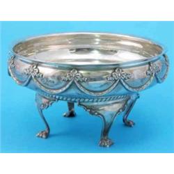 A George V silver rose bowl, with ribbon-tied swag decoration, raised on scroll legs with paw fee...