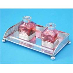 A late Victorian silver inkstand, with three-quarter gallery and two cranberry glass wells, 8.5in...