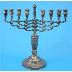 A George V silver menorah, with scroll engraved circular foot, 1934, 22oz....