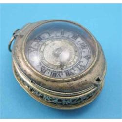 A mid 17th century brass cased pocket watch, of oval form with Roman and Arabic dial, foliate scr...