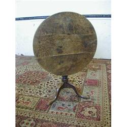 A GEORGE III COUNTRY OAK TRIPOD TABLE, circular tilt top, baluster support, cabriole base, diamet...