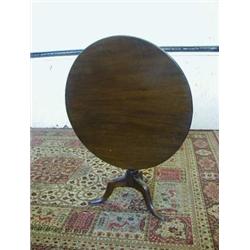 A MAHOGANY PEDESTAL TABLE, early 19th Century, circular two piece top, turned column, tripod cabr...
