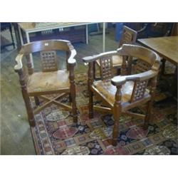 ROBERT 'MOUSEMAN' THOMPSON, a pair of oak corner armchairs, quarter cut raised gallery backs, out...