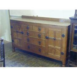 ROBERT 'MOUSEMAN' THOMPSON, an oak sideboard, adzed top, four drawers flanked by a cupboard each...