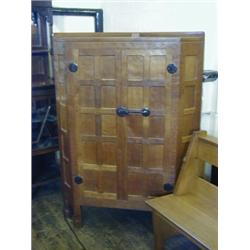 ROBERT 'MOUSEMAN' THOMPSON, an oak corner standing cabinet, twin panelled doors with blacksmith f...