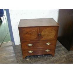 A GEORGE III MAHOGANY COMMODE, formed as a small chest, fold-out top over two false drawers with...