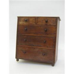A MINIATURE MAHOGANY CHEST OF DRAWERS, 19th century, two short over three long drawers, turned pu...