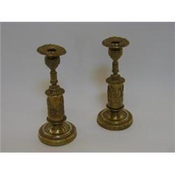 A PAIR OF REGENCY CAST BRASS  CANDLESTICKS, with anthemion moulded drums, height 21cm (2)  30-50...