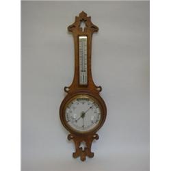 AN ANEROID BAROMETER, 20cm enamel dial below a thermometer, oak case, c1900, height 86cm  100-150...