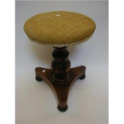 A ROSEWOOD PIANO STOOL, mid 19th Century, circular swivel seat, acanthus carved support, tripod p...