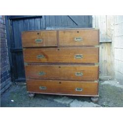 AN OAK CAMPAIGN CHEST OF DRAWERS, c.1830 - 1840, two sections, two short over three graduating te...