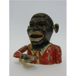 A NOVELTY ALLOY MONEY BOX, modelled as a minstrel, 'Starkie's Patent', height 17cm, (paint losses...