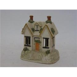 A STAFFORDSHIRE PASTILLE BURNER, mid 19th Century, formed as a double fronted cottage, bocage det...