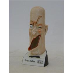 A NOVELTY GERMAN MATCH STRIKER, late 19th Century/early 20th Century, comical head, marked 'Sweet...