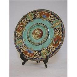 A CIRCULAR FAIENCE PLAQUE, late 19th Century,  transfer printed and over-painted Renaissance deco...