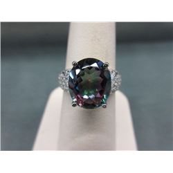 RING - 4.5CT OVAL FACETTED TOPAZ IN STERLING SILVER SETTING - INCUDES 24 FACETTED CZ ACCENT STONES -