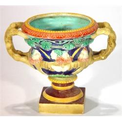 Square based Majolica two handled urn, reli…