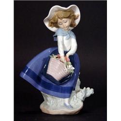 Hand painted Lladro girl clutching a basket…
