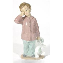 Hand painted Nao porcelain boy clutching a …