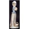 Image 1 : Hand painted Nao figurine clutching a puppy…