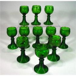 Eleven green glass goblets etched and gilde…