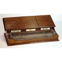 Oak deskstand with three pottery inkwells a…