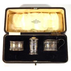 Cased silver three piece cruet with blue gl…